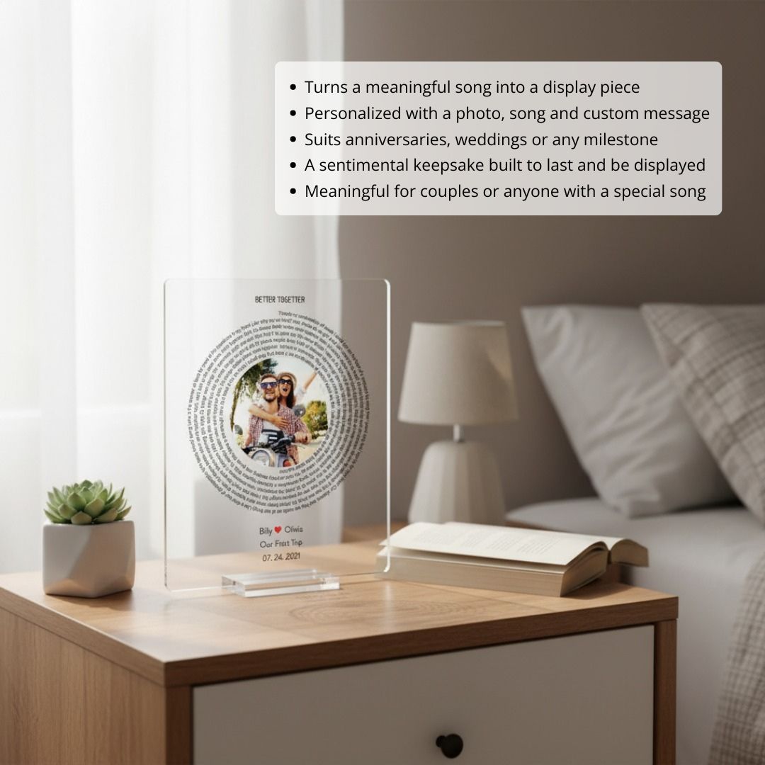 Personalized acrylic plaque displayed on bedroom nightstand, featuring sample photo of couple, "BETTER TOGETHER" heading, circular song lyric design, and example names "Billy" and "Olivia" with date "07.24.2021