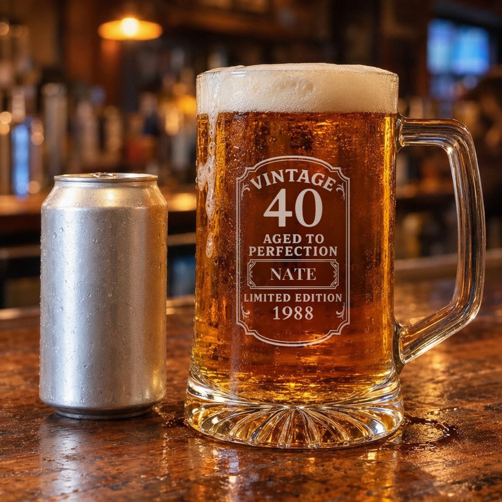 25 oz vintage 40th birthday beer stein beside a 12 oz beer can on a bar for size, engraved with the name Nate and the year 1988