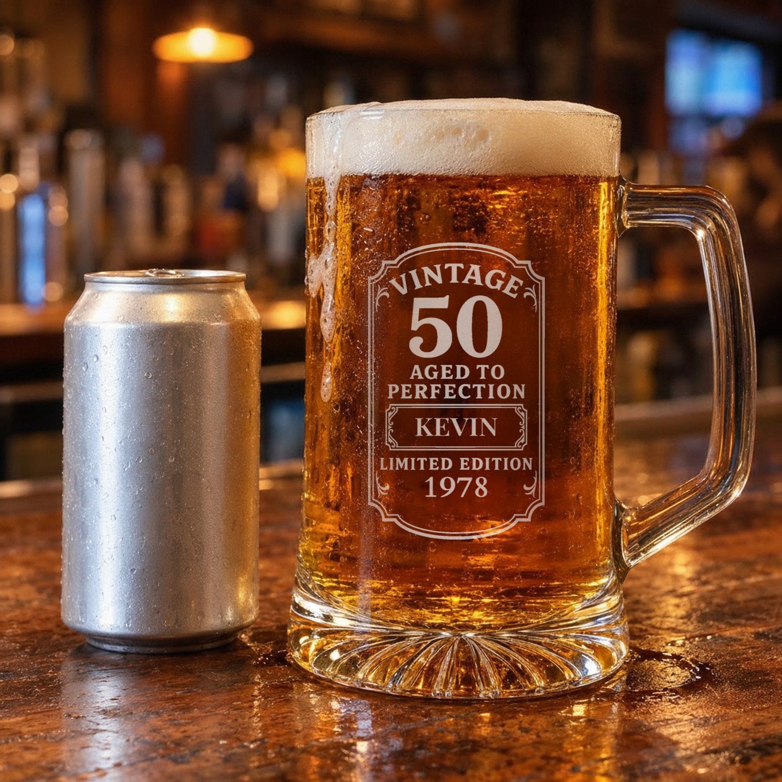 25 oz vintage 50th birthday beer stein beside a 12 oz beer can on a bar for size, engraved with the name Kevin and the year 1978