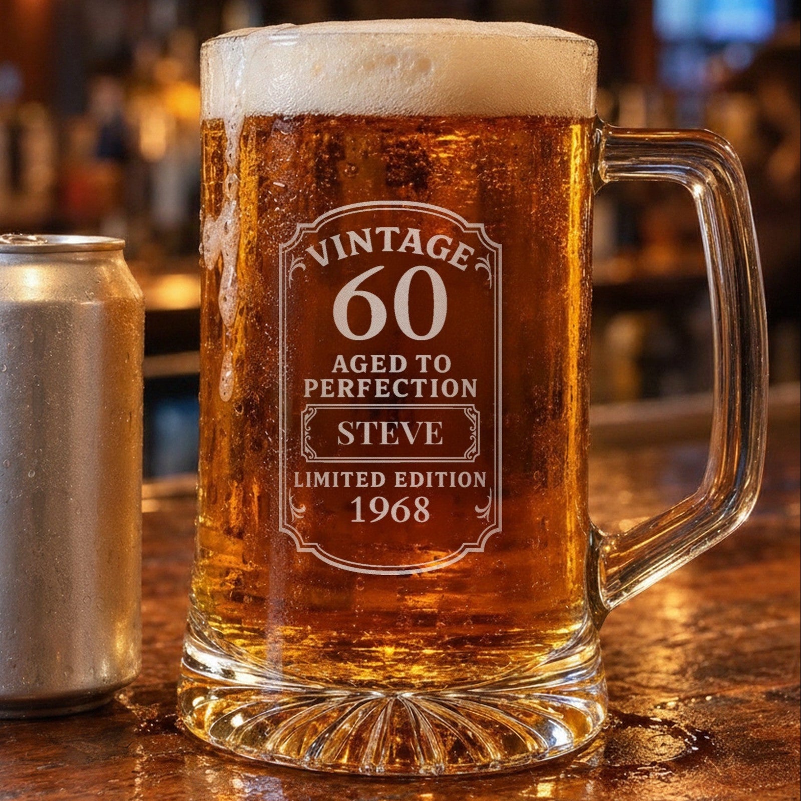 25 oz vintage 60th birthday beer stein beside a 12 oz beer can on a bar for size, engraved with the name Steve and the year 1968