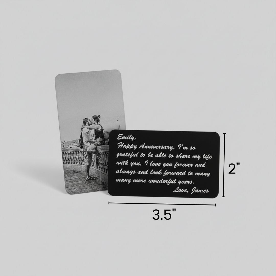 Black aluminum wallet insert card with sample anniversary message engraved on back, paired with photo insert showing couple embracing, dimensions 3.5" x 2