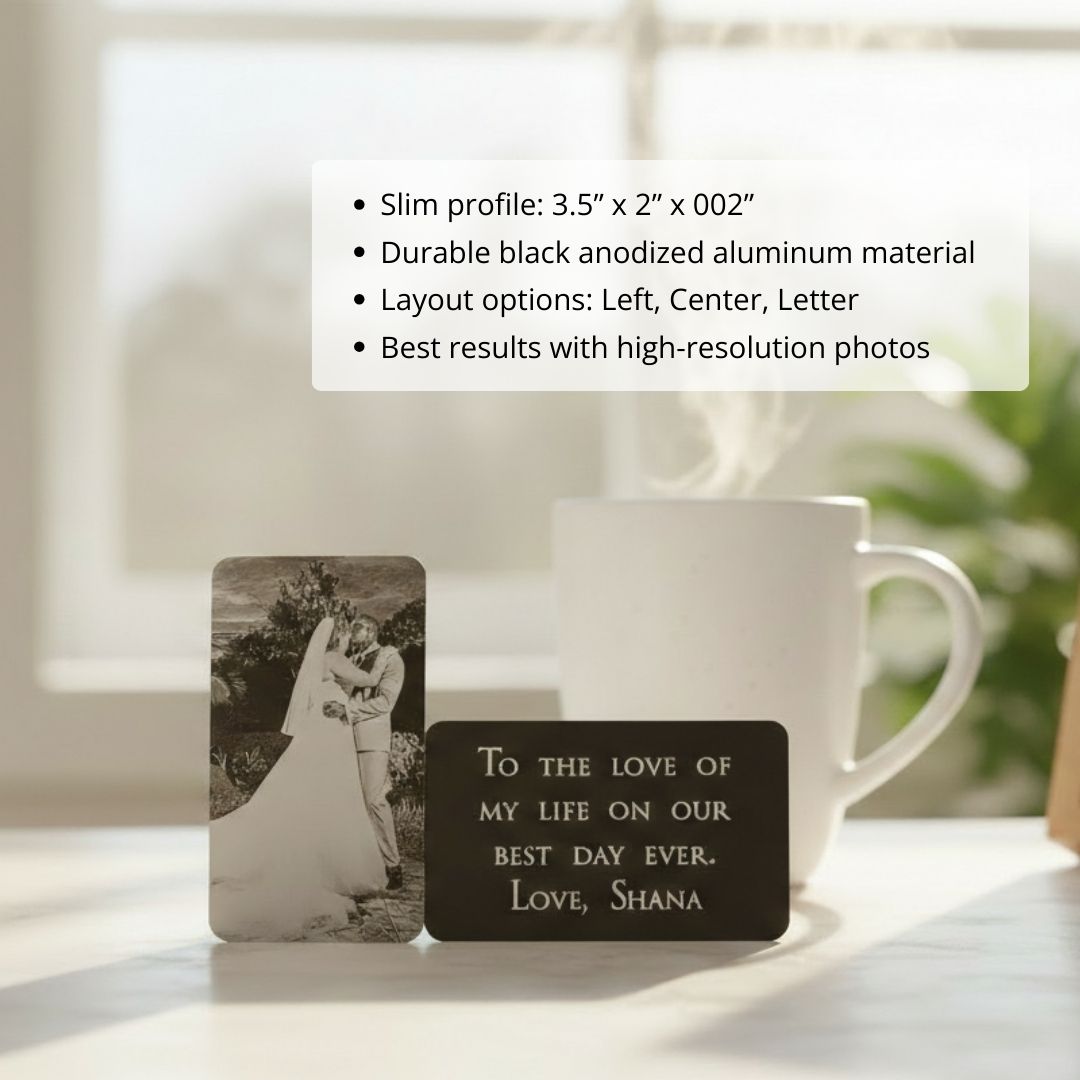 Black anodized aluminum wallet insert with laser-engraved photo on front and personalized message sample reading "To the love of my life on our best day ever. Love, Shana" on back, displayed next to white mug.