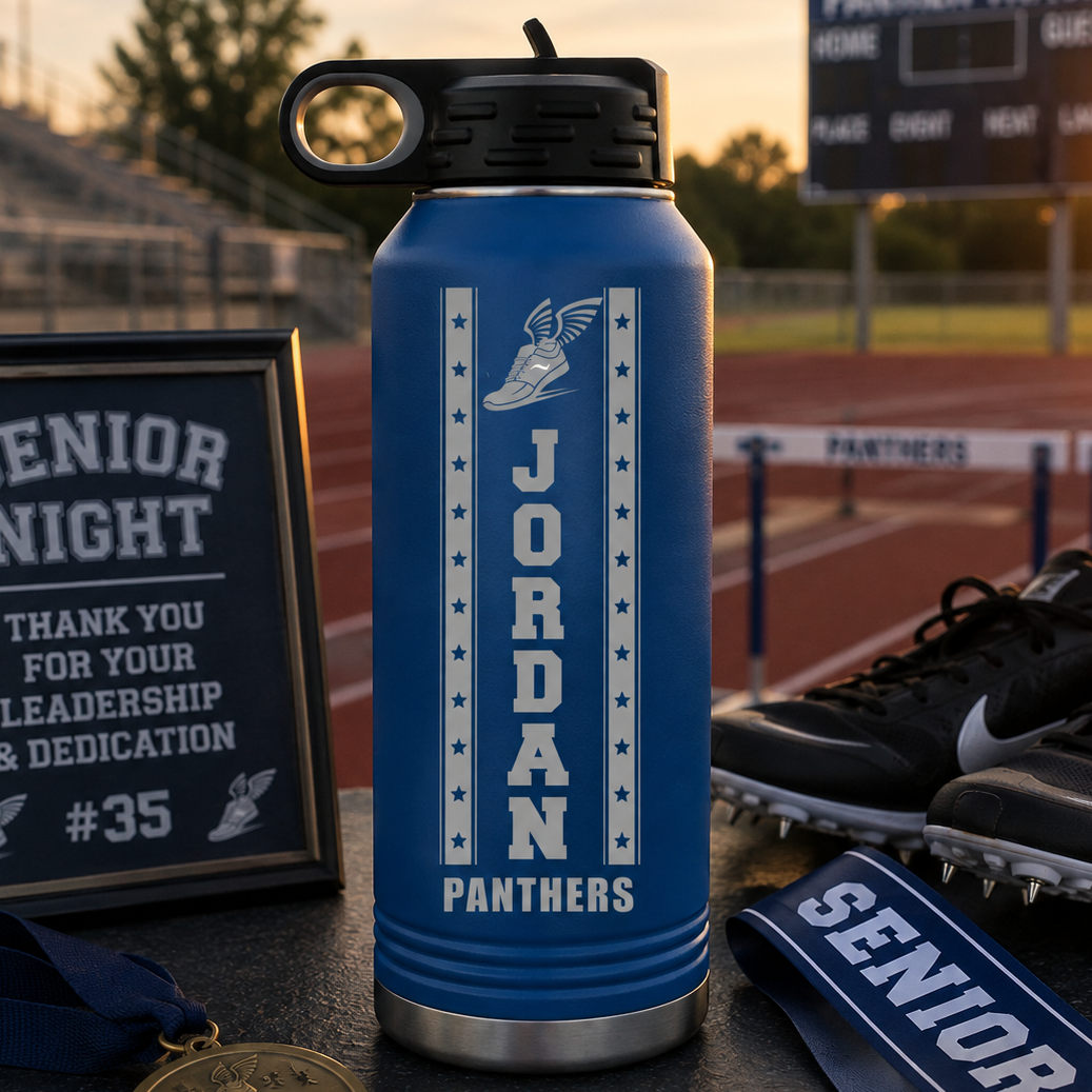 Blue insulated water bottle with sample personalization reading "JORDAN PANTHERS" and winged shoe logo, displayed on a baseball field with senior night memorabilia