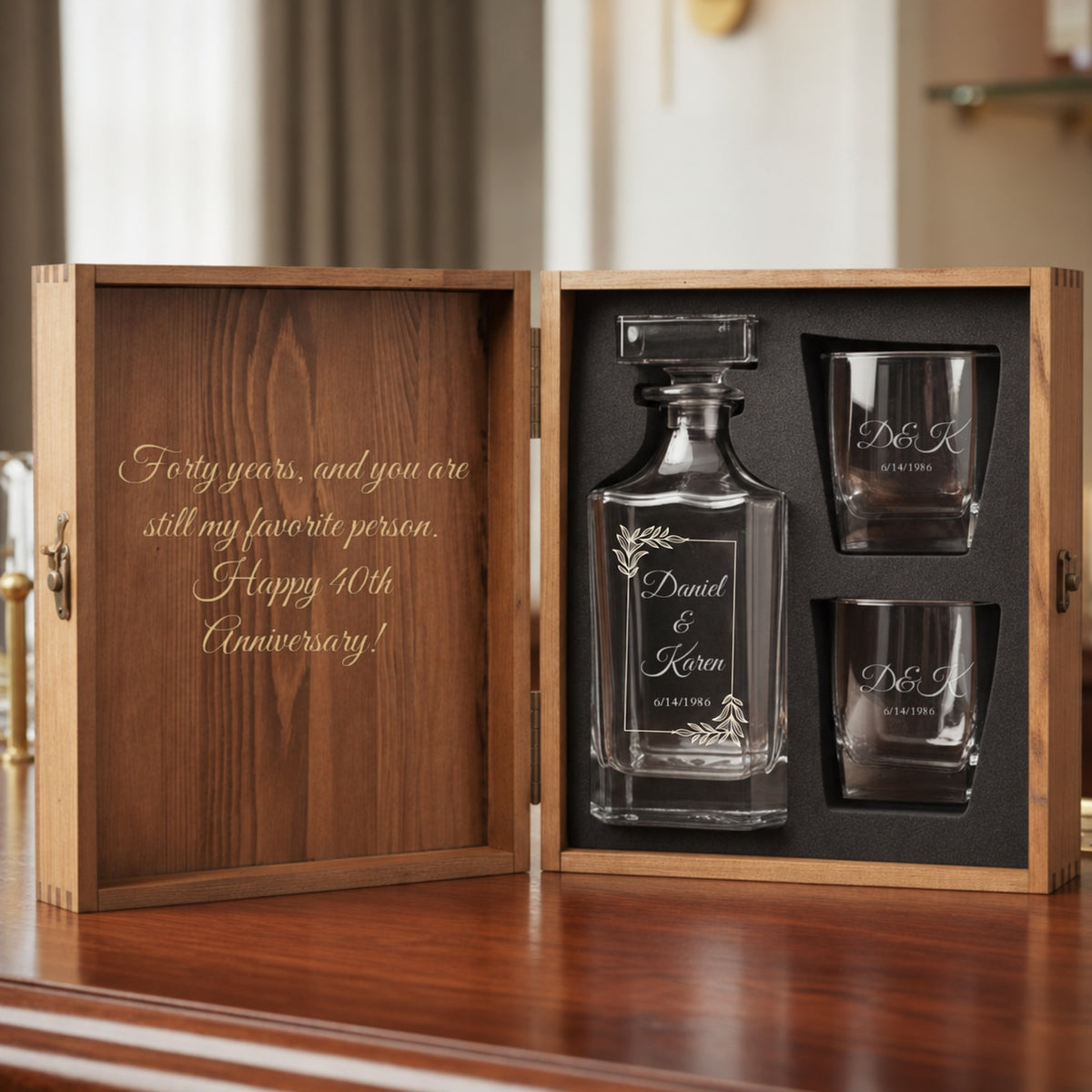 Personalized whiskey decanter set for a 40th anniversary in an open pine chest, names and wedding date on the decanter, initials on two rocks glasses, a message inside the lid