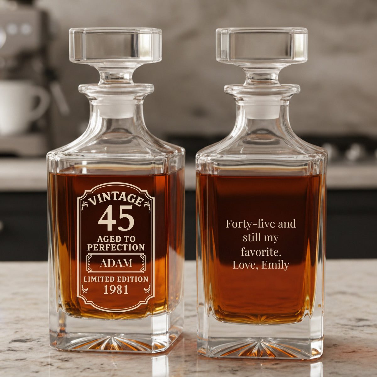 Personalized Vintage 45 decanters on a marble counter with ADAM and 1981 on the front and a note from Emily on the back, one of our 45th birthday gifts for him