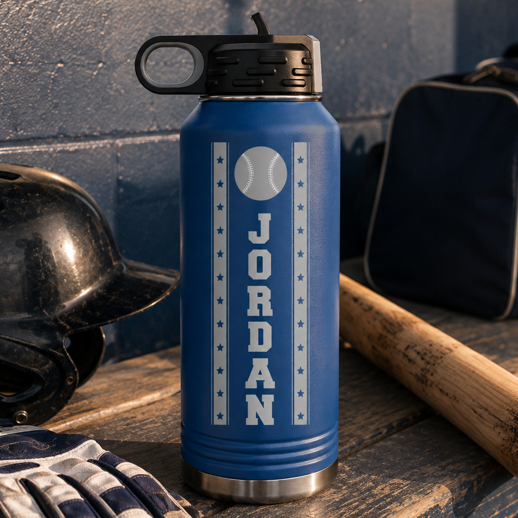 Blue insulated water bottle with black spout cap, engraved with sample name "JORDAN" and baseball graphic surrounded by stars.
