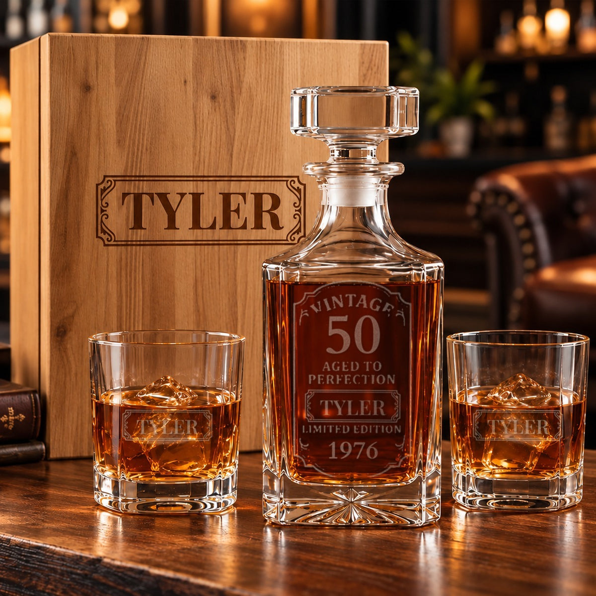 Whiskey decanter etched Vintage 50 Aged to Perfection with the sample name TYLER and 1976, two matching etched glasses and a pine gift box with the name on the lid
