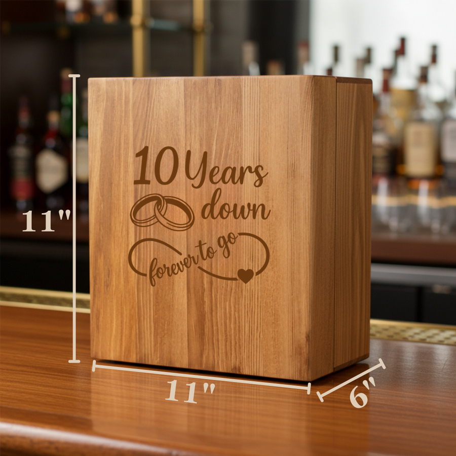 Wood decanter box with engraved sample text "10 Years down forever to go" and decorative rings and heart, shown with dimensions 11" x 11" x 6