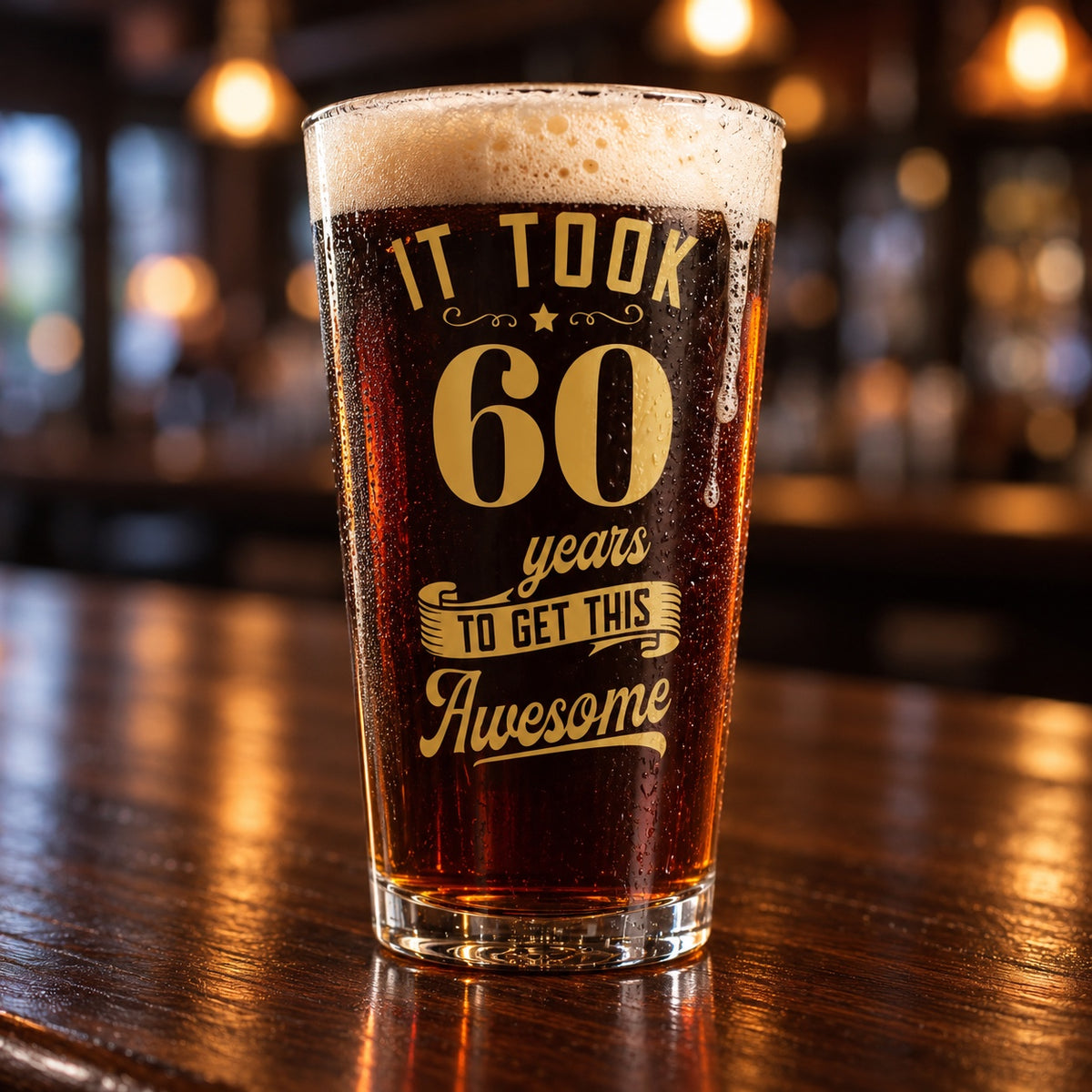 60th birthday beer glass full of dark ale on a walnut bar, printed in gold with It Took 60 Years to Get This Awesome for his milestone toast