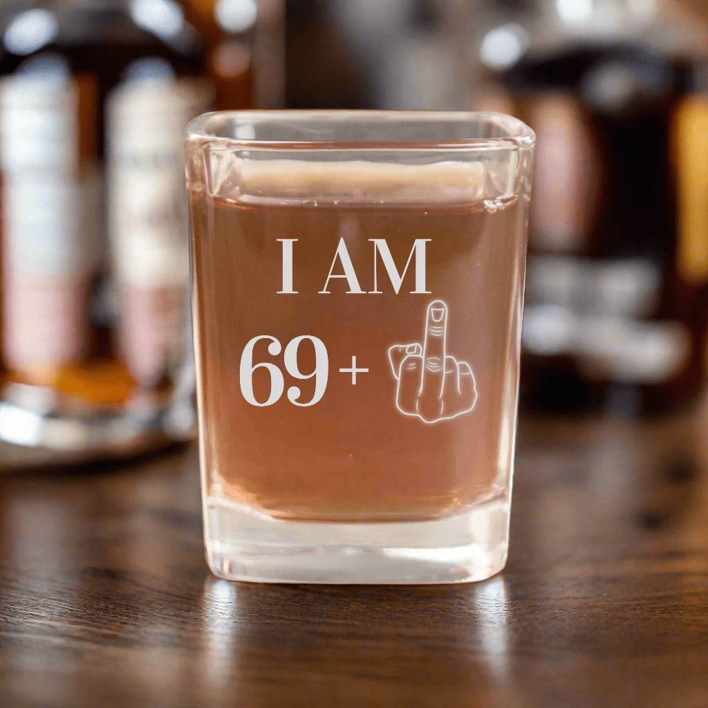 The original 70th birthday shot glass photo: I AM 69 plus a middle finger engraved on a square glass, a funny gift for the big birthday party