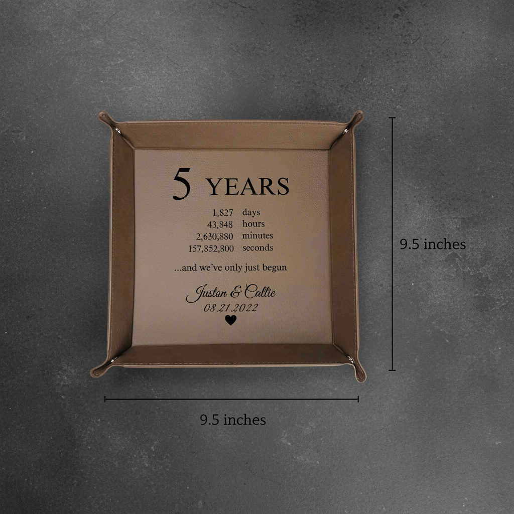 Tan leather valet tray with personalized engraving showing "5 YEARS" breakdown and sample names "Justen & Callie" with date "08.21.2022", measuring 9.5 inches square