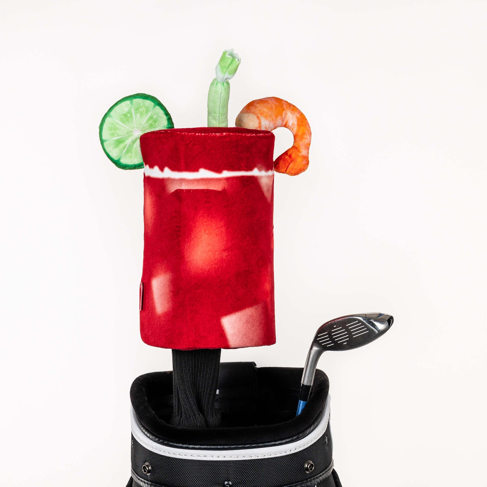 Plush Bloody Mary golf headcover covering a club in a golf bag, a standout golf gift for men from Groovy Guy Gifts