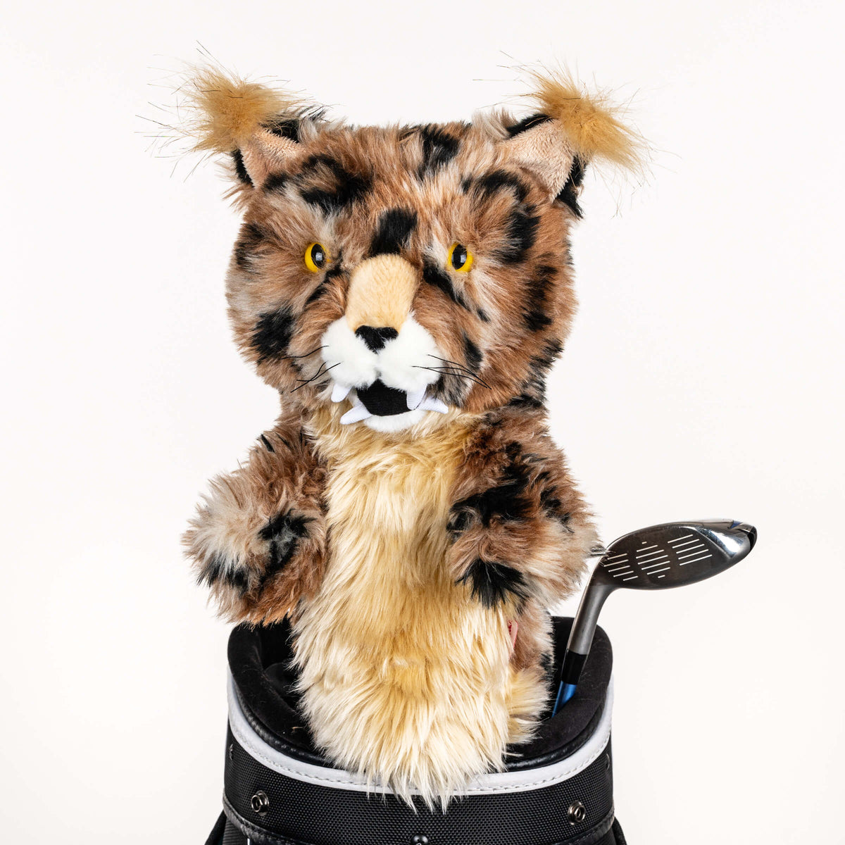 Plush bobcat golf headcover covering a club in a golf bag, a standout golf gift for men from Groovy Guy Gifts