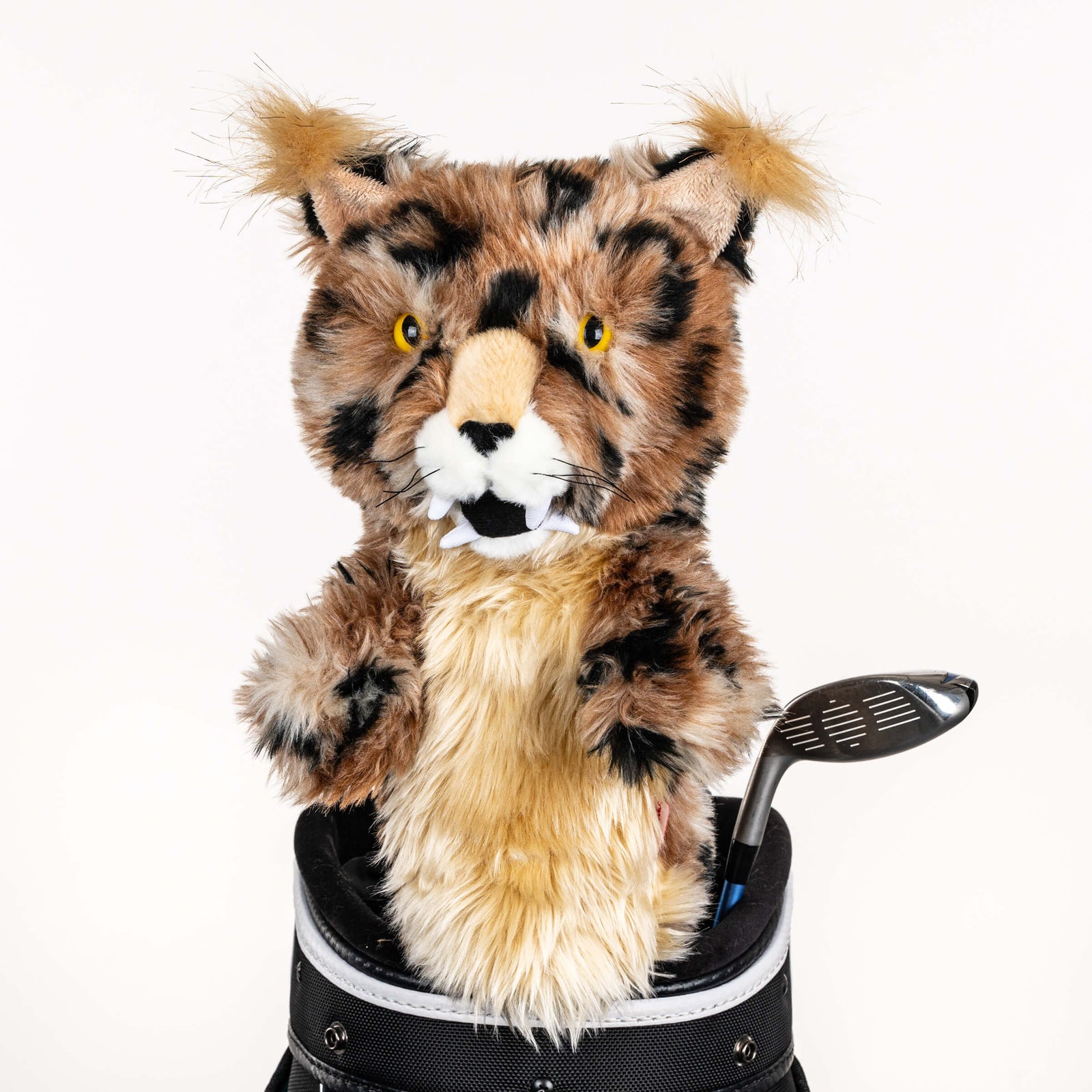 Plush bobcat golf headcover covering a club in a golf bag, a standout golf gift for men from Groovy Guy Gifts