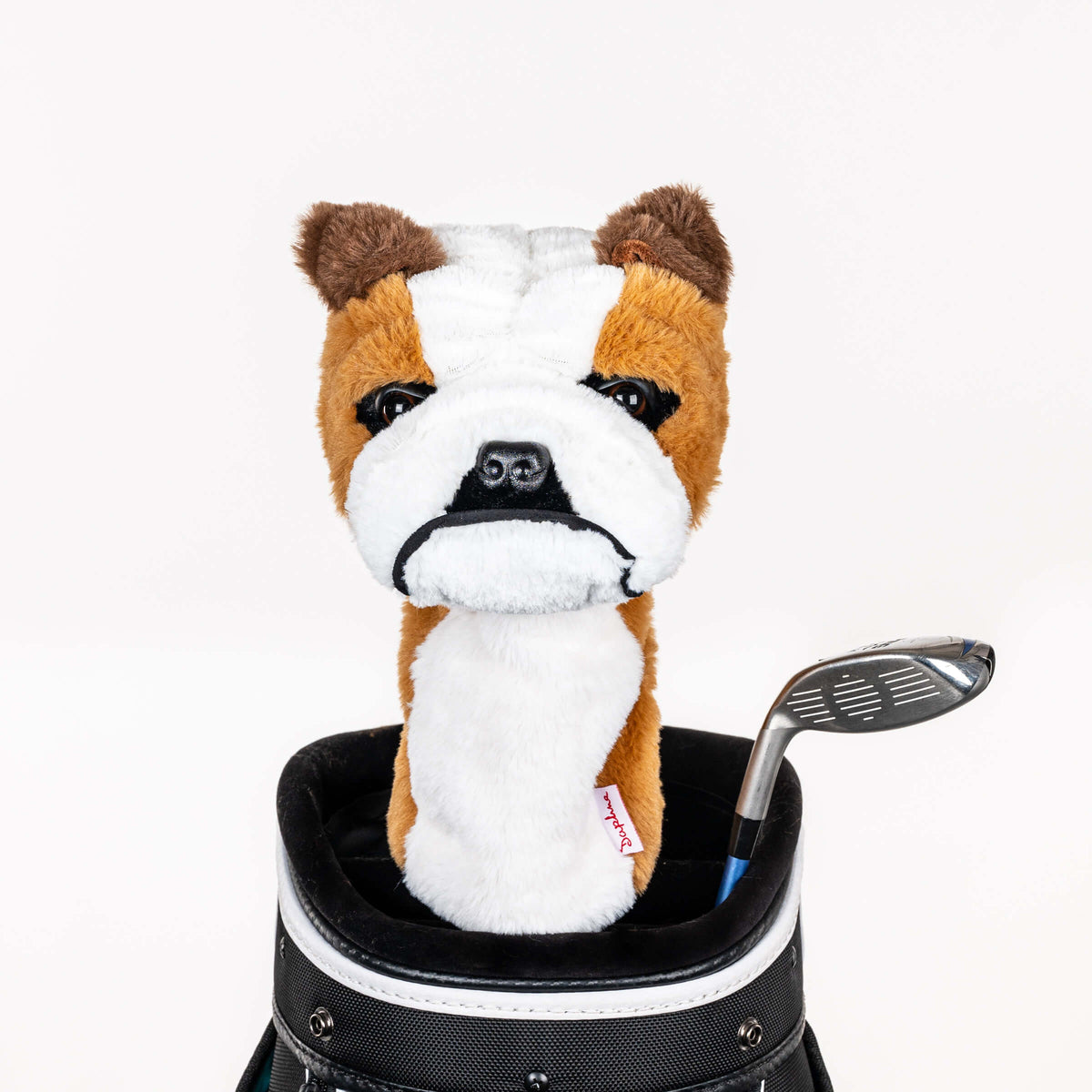 Plush bulldog golf headcover covering a club in a golf bag, a standout golf gift for men from Groovy Guy Gifts