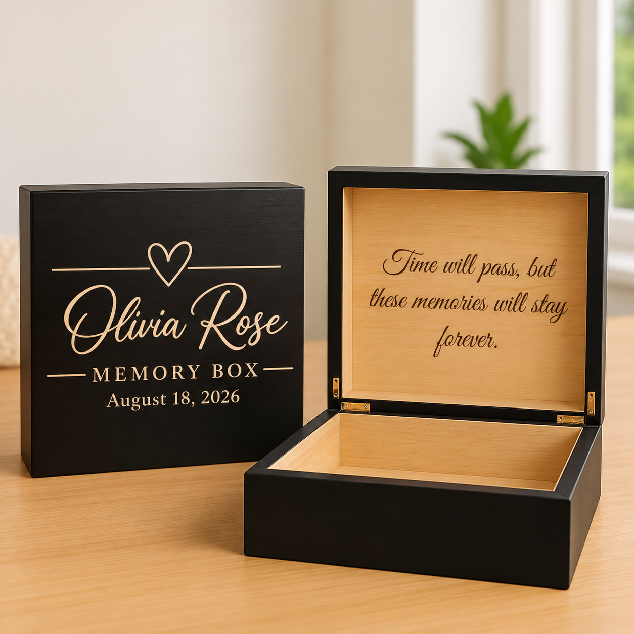 Two black memory boxes with engraved personalization sample showing child's name, heart detail, and date, with open box displaying tan interior and inspirational quote.