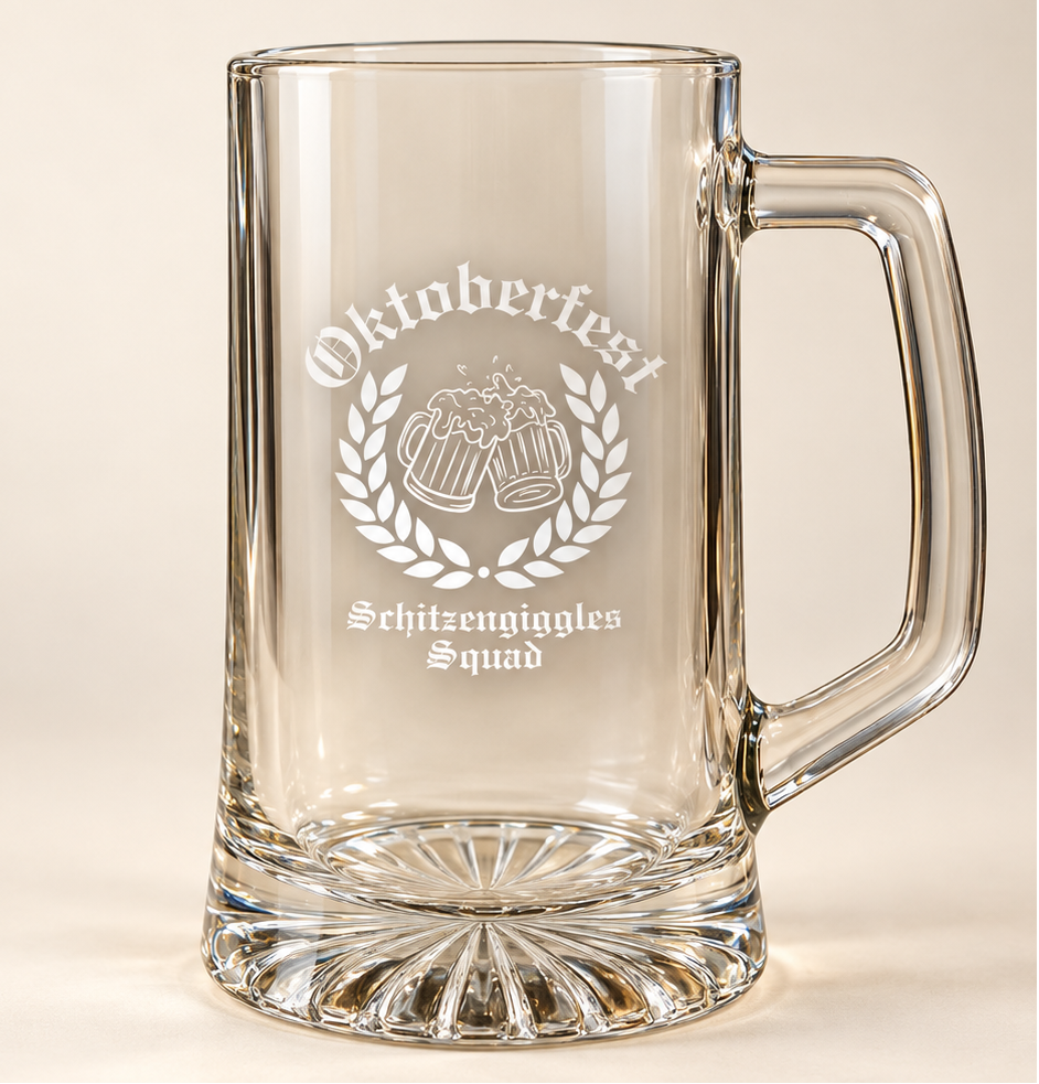Empty personalized Oktoberfest glass beer stein on a cream background, showing the frosted engraving, the tall handle and the thick cut glass starburst base