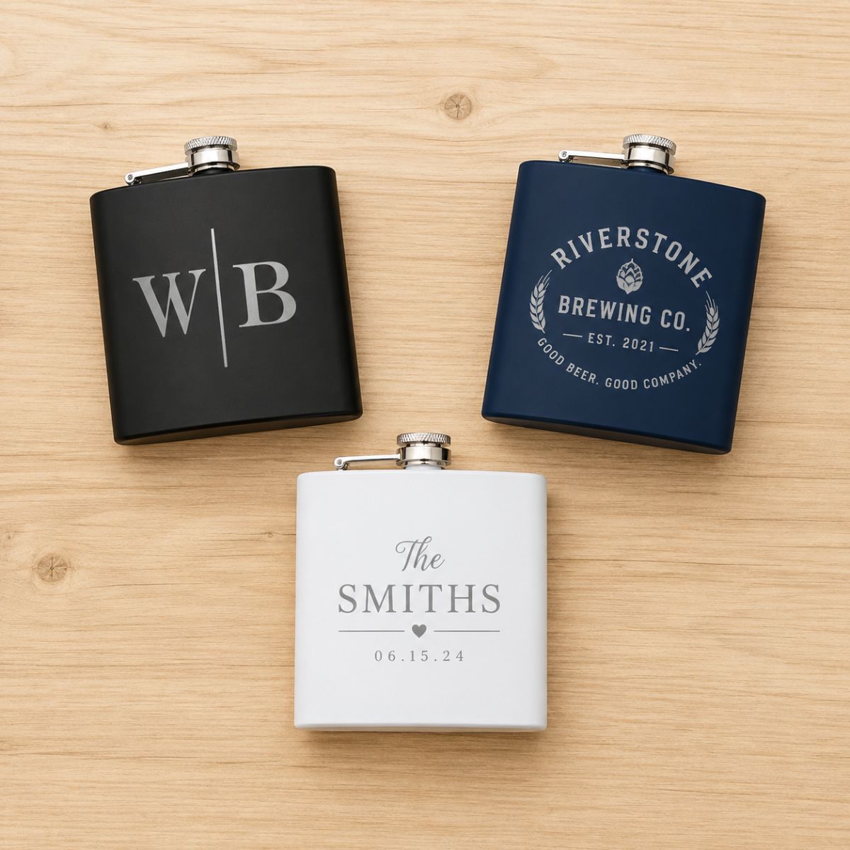 Three flasks with engraved text on a wooden surface