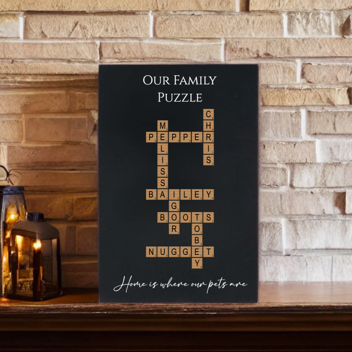 Black wall sign displaying "Our Family Puzzle" with sample family names arranged in crossword style, including Pepper, Mills, Bailey, Boots, and Nugget, with tagline "Home is where our pets are