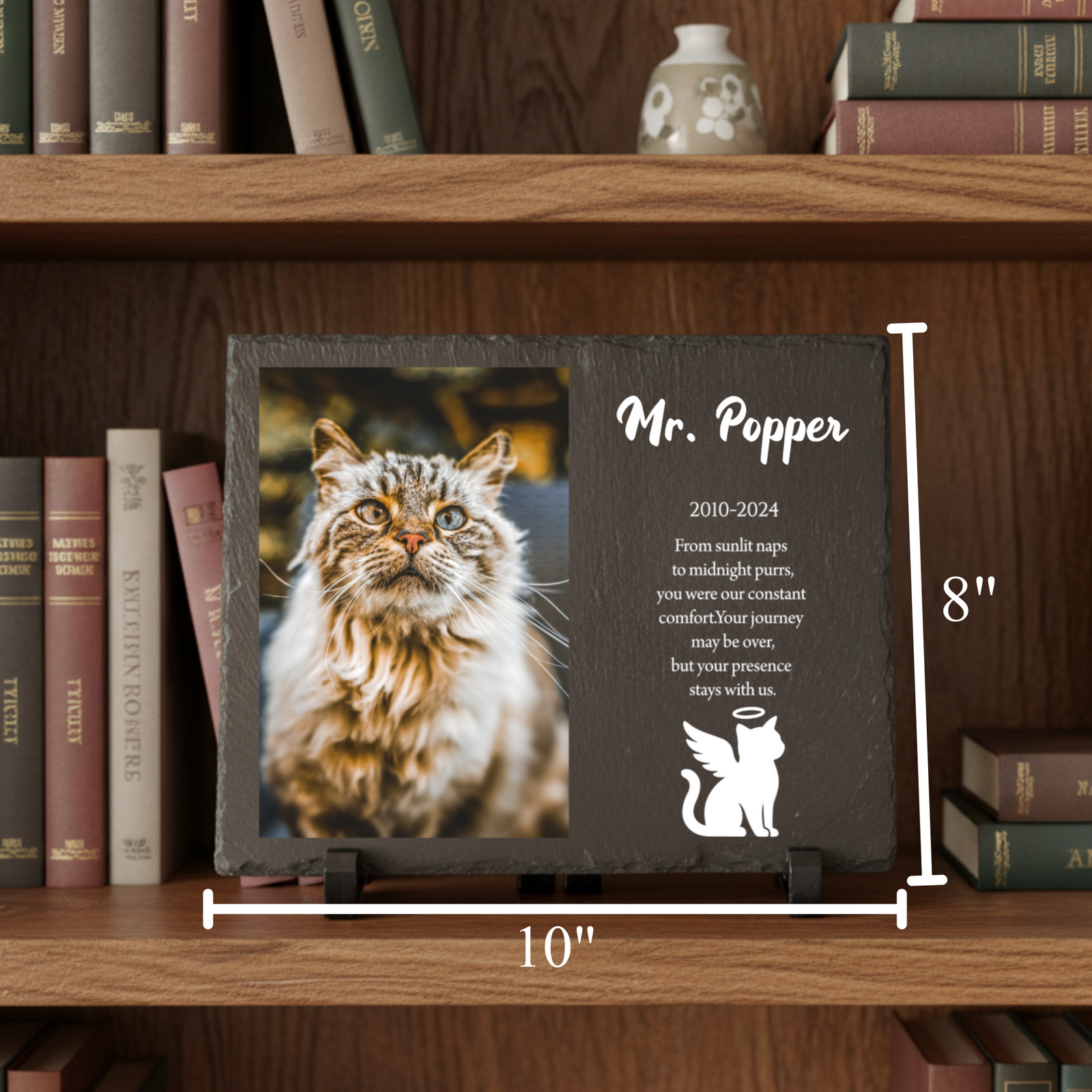 Dark slate memorial plaque personalized with sample pet name "Mr. Popper," photo, dates 2010-2024, and custom tribute message with angel cat silhouette, displayed on wooden shelf.
