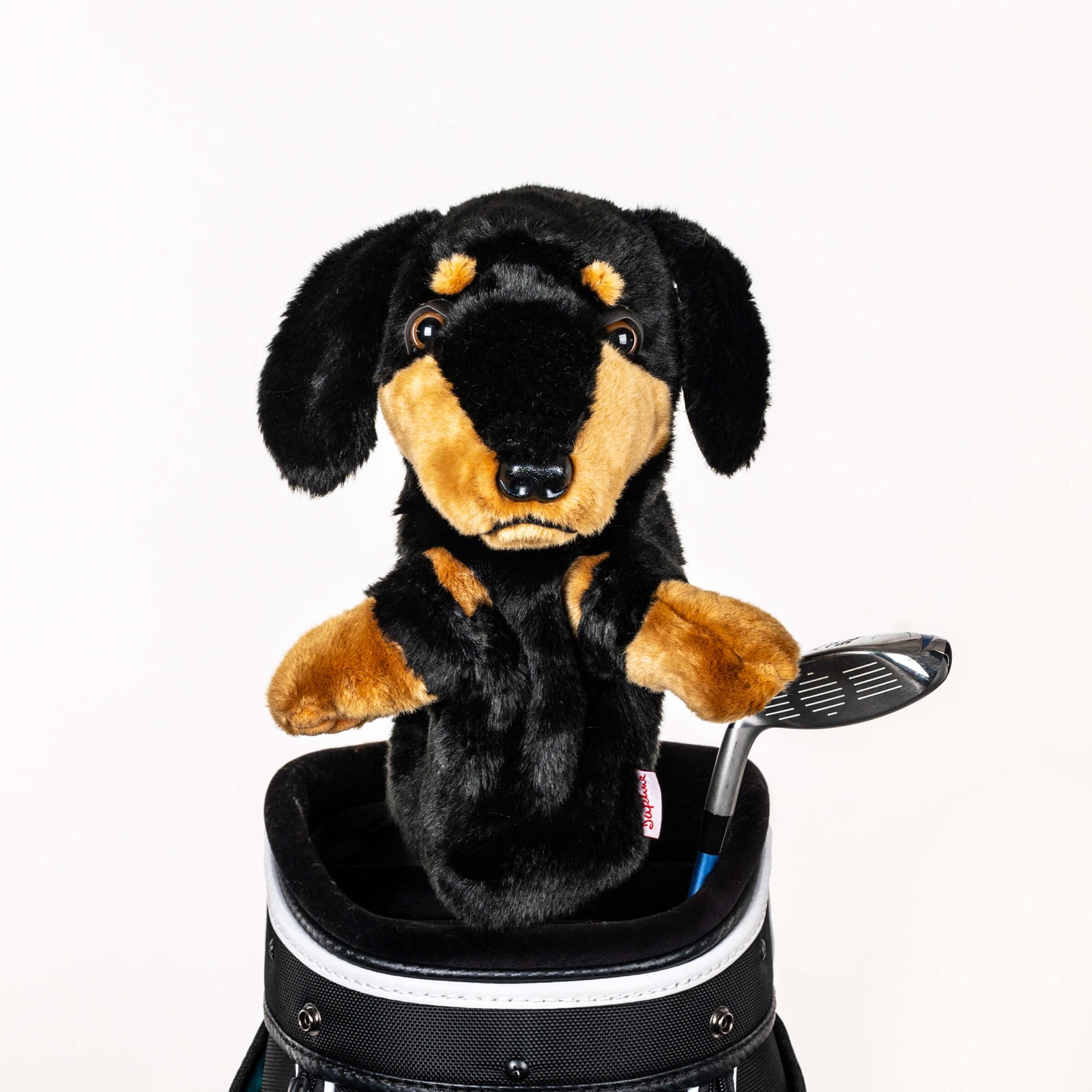 Plush dachshund golf headcover covering a club in a golf bag, a standout golf gift for men from Groovy Guy Gifts