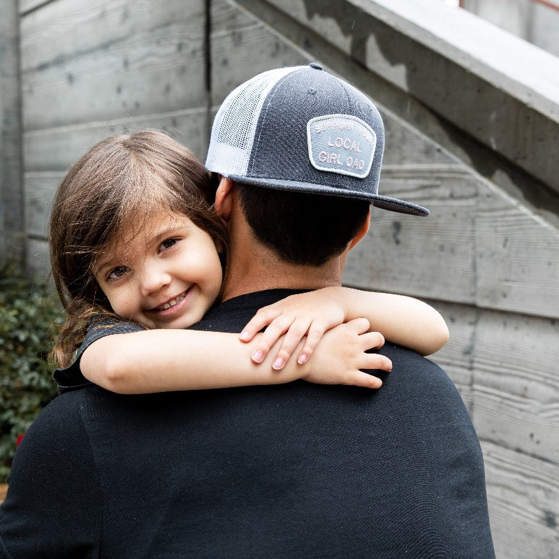 Support Your Local Girl Dad flat bill mesh hat with embroidered patch, charcoal/white and black options.