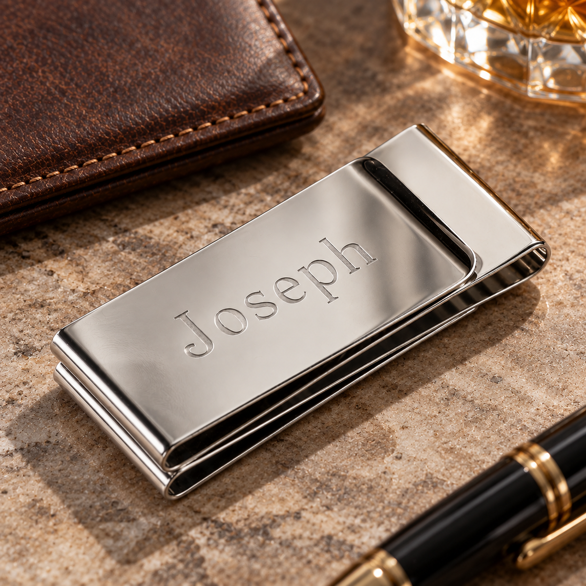 Personalized money clip in mirror-polished stainless steel, the name Joseph engraved across the front, a custom money clip gift for him