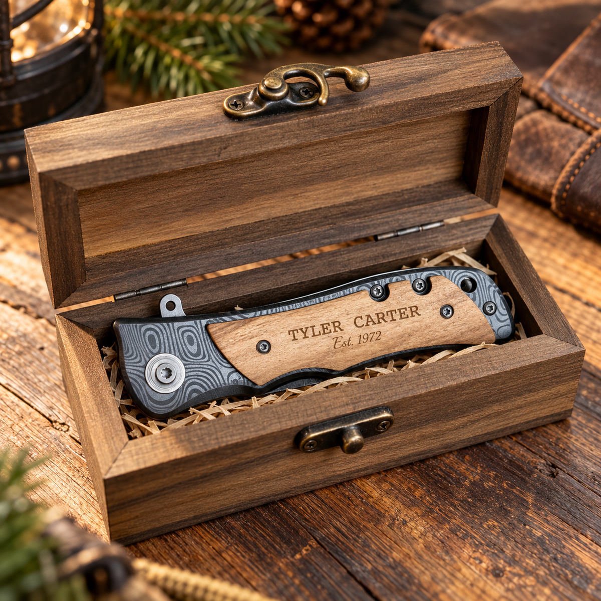 Engraved folding knife resting inside its open wooden gift box with sample name Tyler Carter on the natural wood handle, ready to give for his 80th