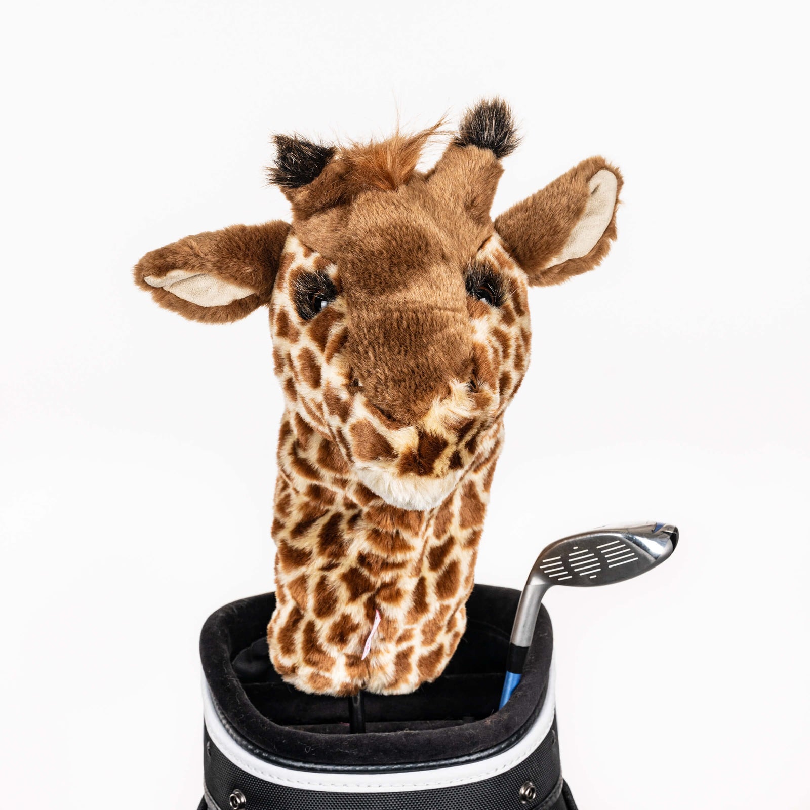 Plush giraffe golf headcover covering a club in a golf bag, a standout golf gift for men from Groovy Guy Gifts