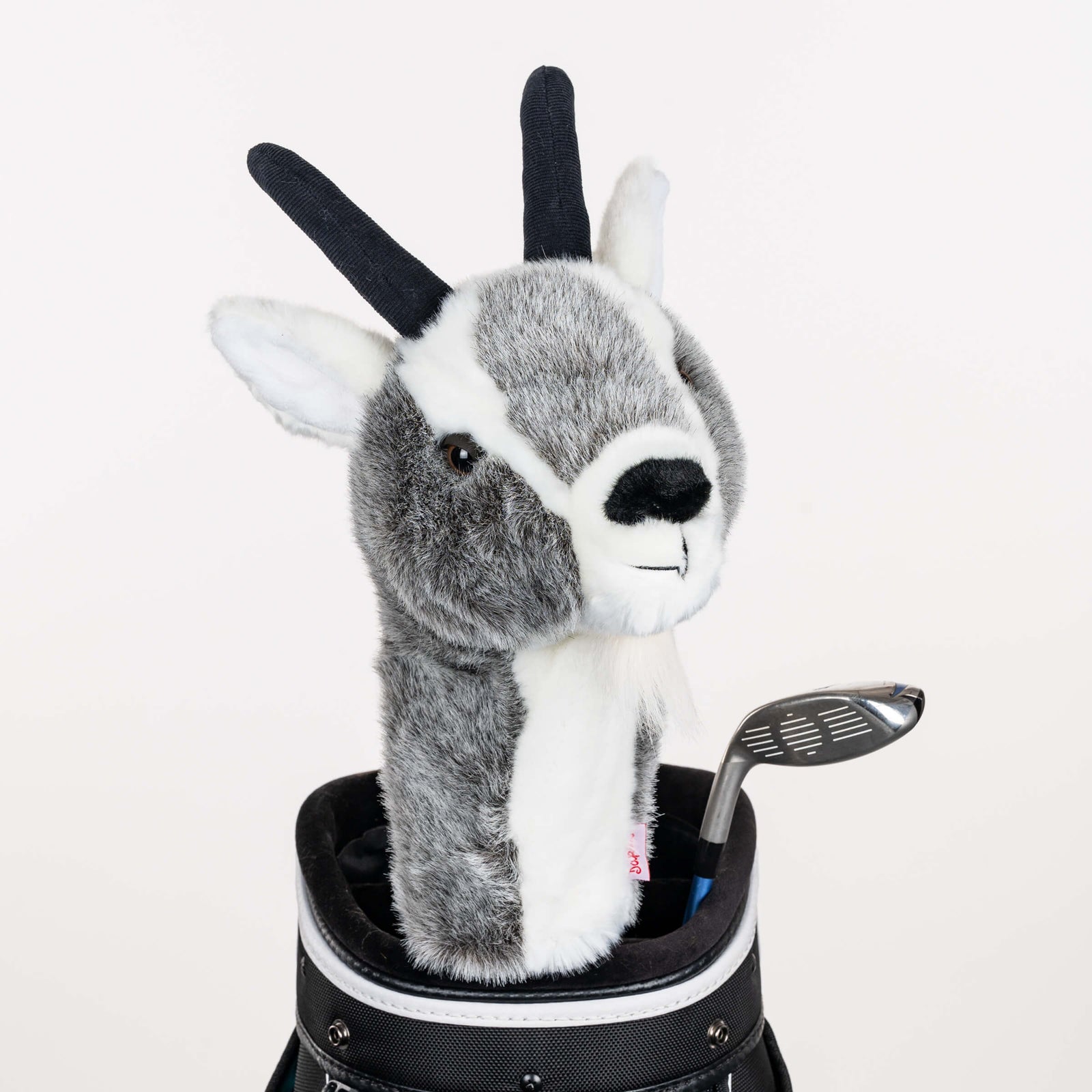 Plush goat golf headcover covering a club in a golf bag, a standout golf gift for men from Groovy Guy Gifts