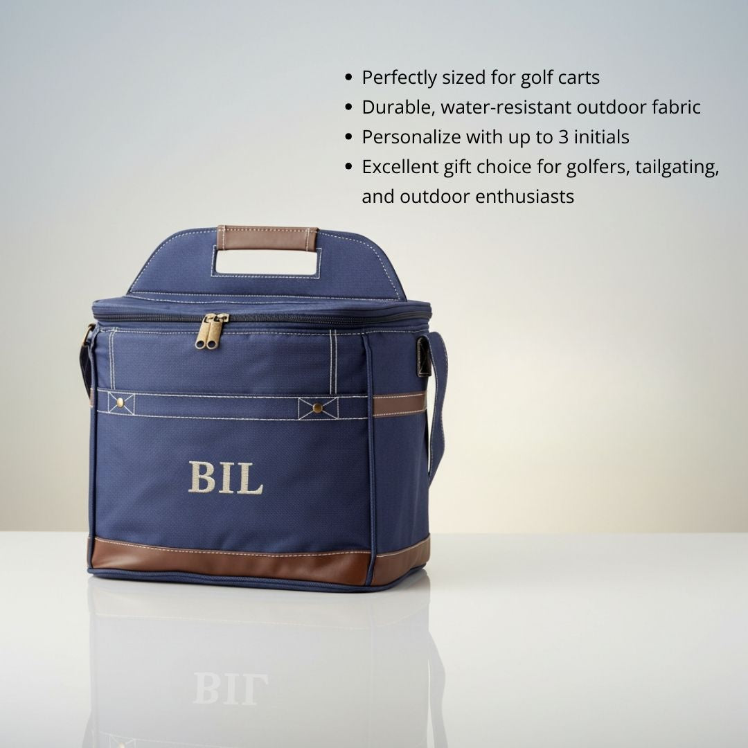 Navy canvas cooler bag with brown leather trim, embroidered with sample monogram "BIL", featuring carrying handles and brass zipper closure