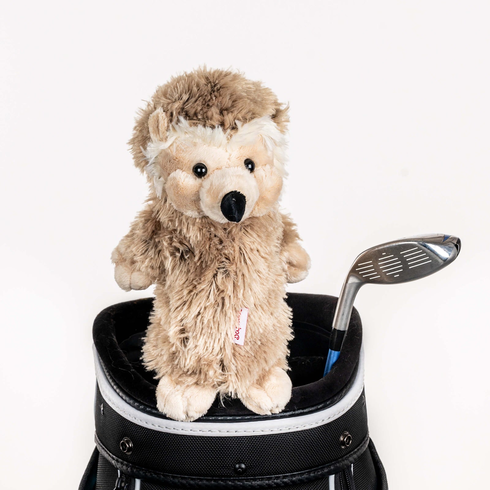 Plush hedgehog golf headcover covering a club in a golf bag, a standout golf gift for men from Groovy Guy Gifts