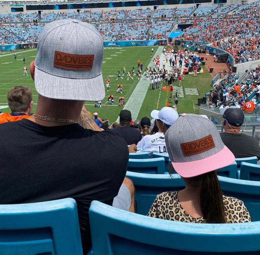 Heather grey Dad Vibes hat with brown leather patch and adjustable snapback.
