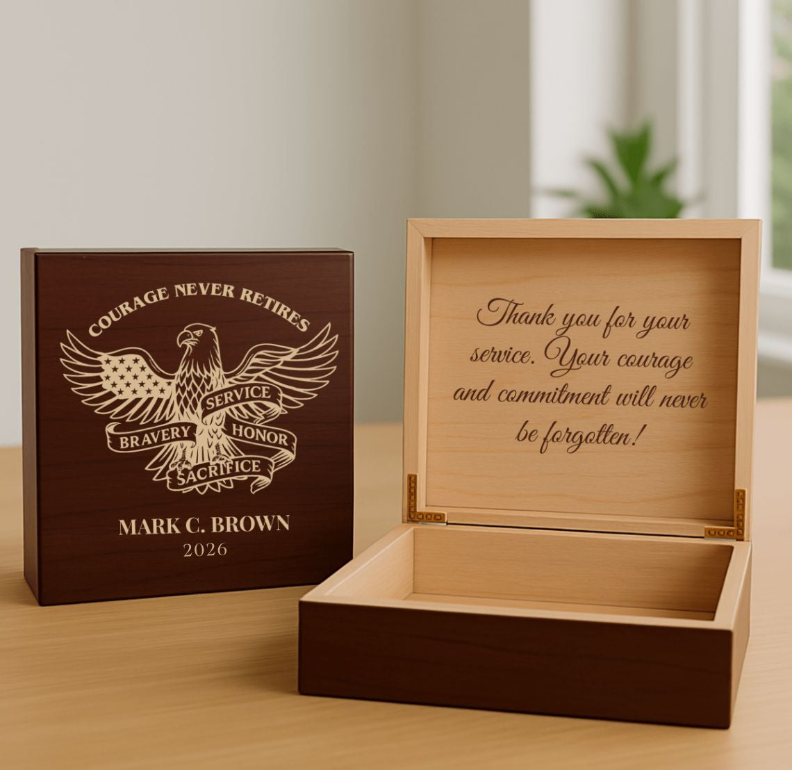 Wooden military retirement gift box with engraved message and eagle design on a wooden surface.