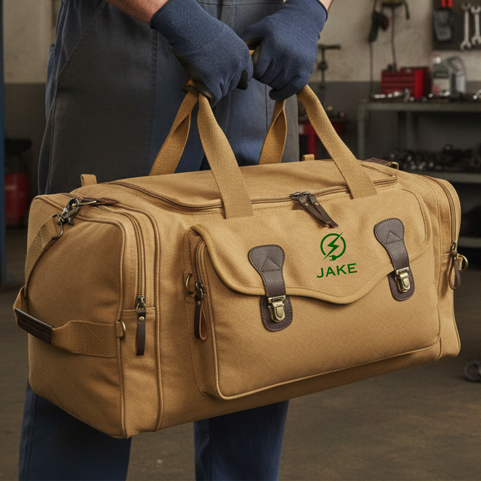 Khaki personalized electrician duffle bag embroidered JAKE in green with a lightning bolt, carried by an electrician in a garage workshop.