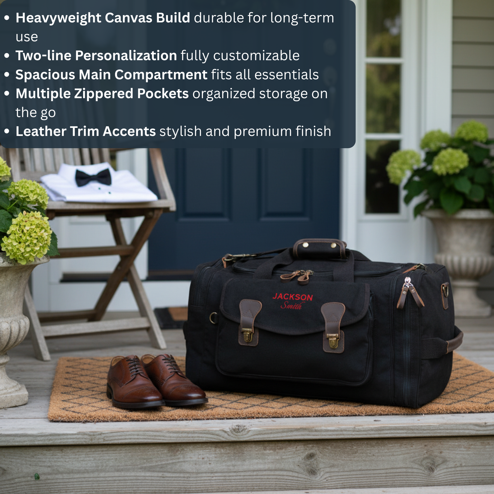 Black canvas duffle with brown leather trim and sample personalization "JACKSON Smith" in red lettering, displayed on porch with brown oxford shoes