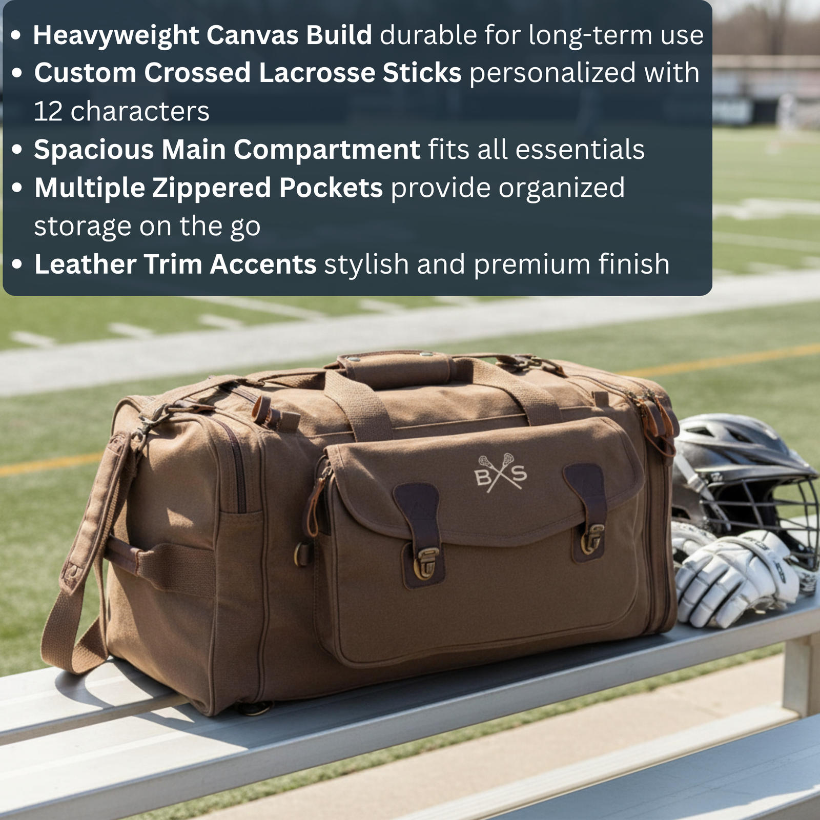 Tan canvas lacrosse duffle bag with crossed sticks logo and leather accents, positioned on bench next to helmet and gloves at field