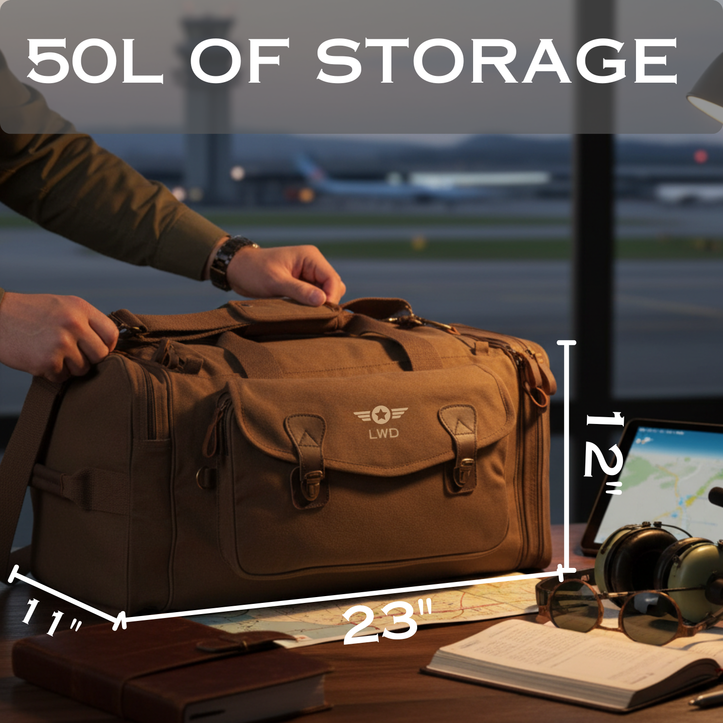 Brown canvas pilot duffel bag with embroidered wings and initials "LWD", displayed with dimensions 23" × 12" × 11", shown on table with maps and aviator sunglasses