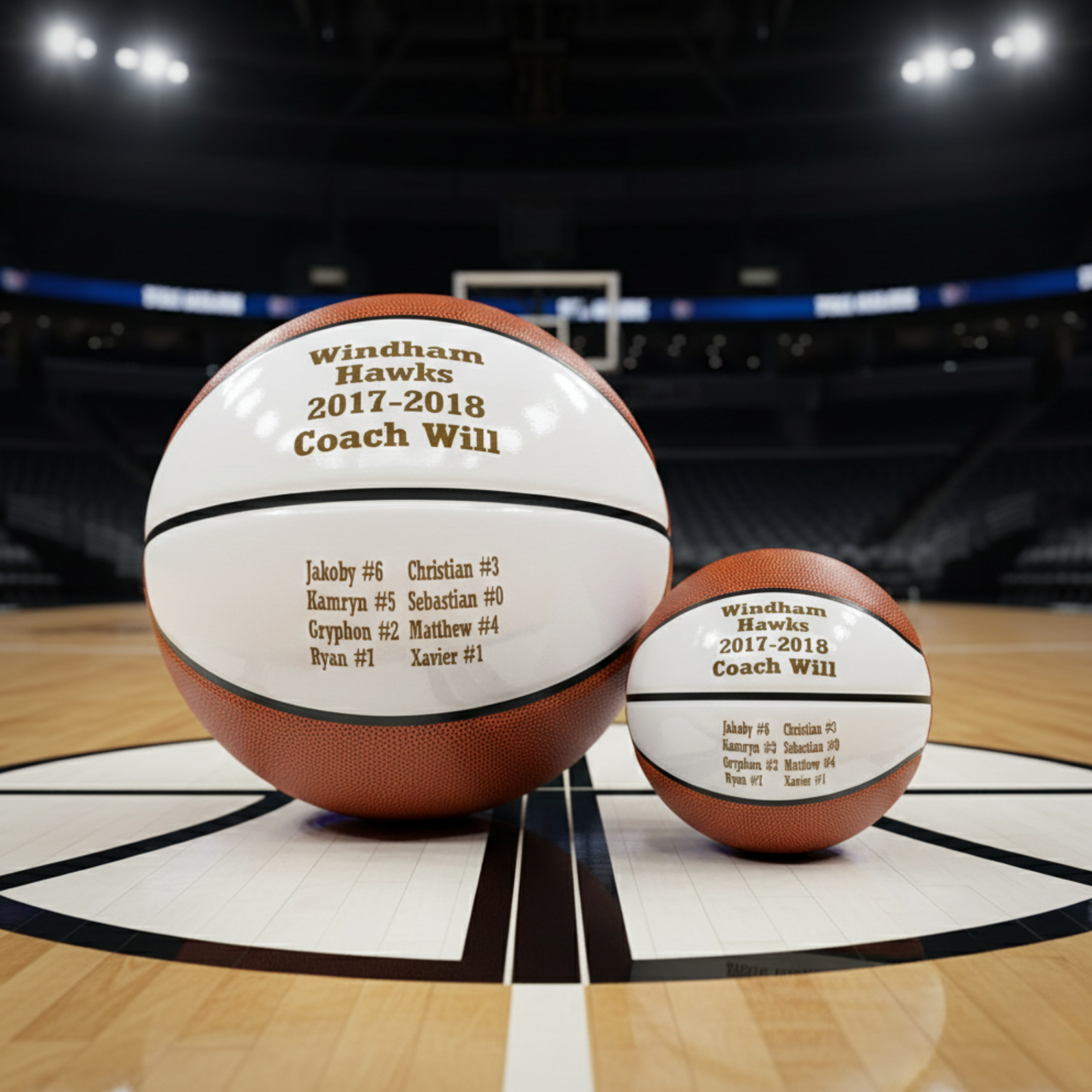 Full-size and mini basketballs engraved with sample personalization showing "Windham Hawks 2017-2018 Coach Will" and roster names with jersey numbers on white panels