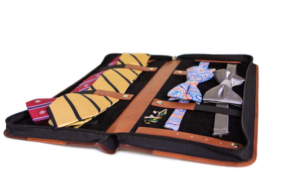 Brown vegan leather travel tie case with plush black interior, holds ties, cufflinks, and clips.