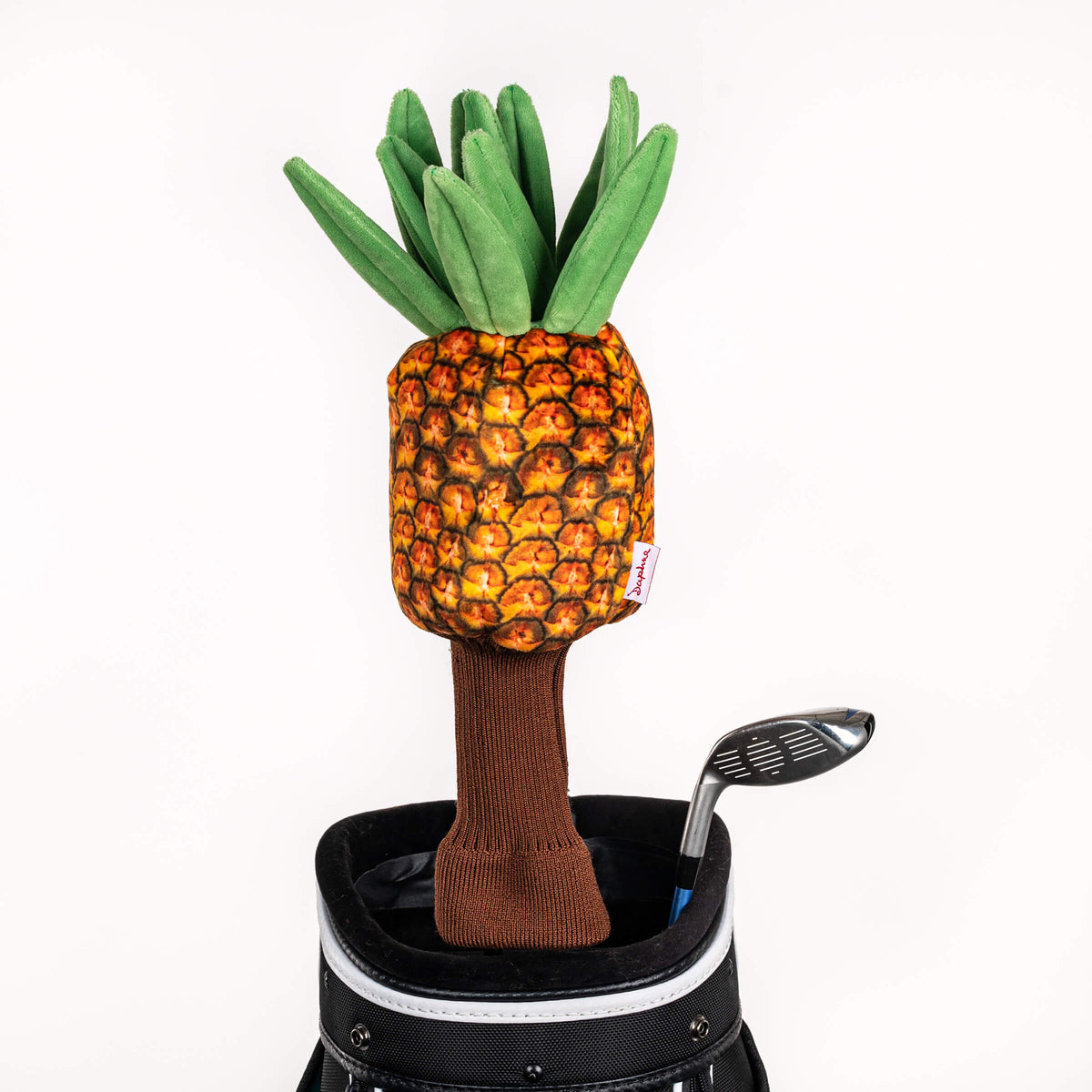 Plush pineapple golf headcover covering a club in a golf bag, a standout golf gift for men from Groovy Guy Gifts
