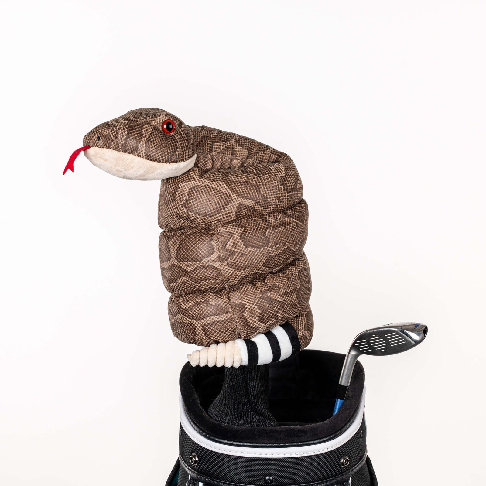 Plush rattlesnake golf headcover covering a club in a golf bag, a standout golf gift for men from Groovy Guy Gifts