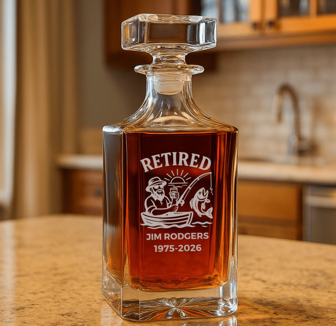 Glass fishing decanter with engraved retirement design on a kitchen counter