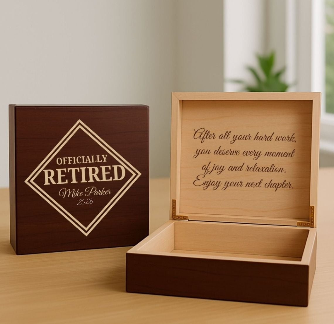 Wooden retirement gift box with engraved message on a wooden surface.