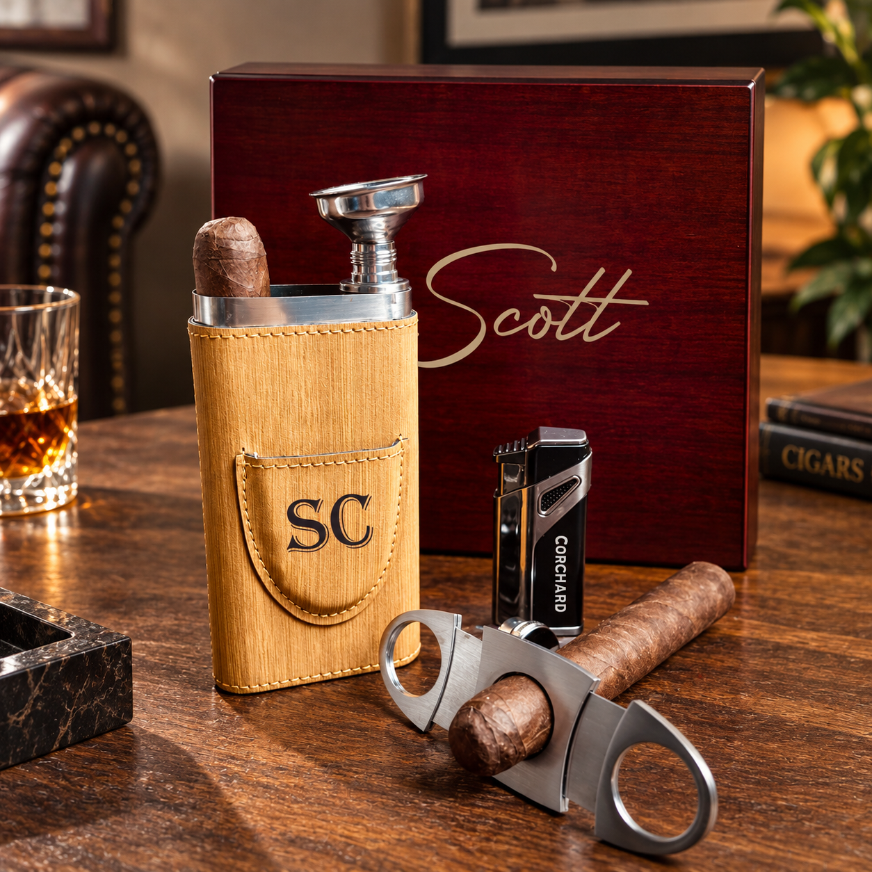 Dark wood cigar gift box with sample engraving reading "Scott," paired with bamboo cigar holder engraved "SC," cigar cutter, lighter, and sample cigar on wooden surface