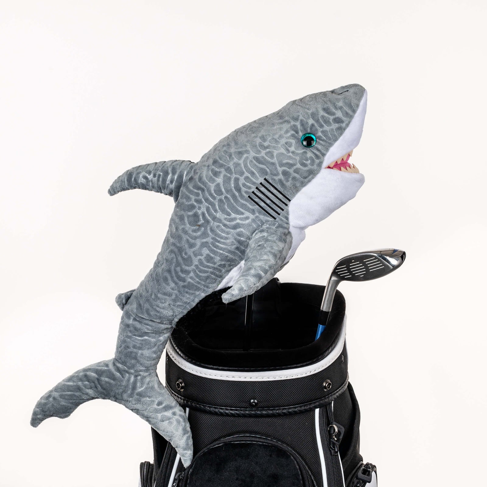 Plush shark golf headcover covering a club in a golf bag, a standout golf gift for men from Groovy Guy Gifts
