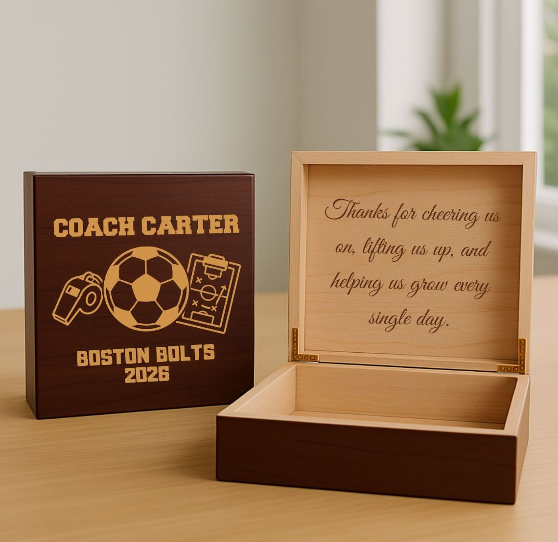 Personalized wooden soccer coach keepsake box with engraved message and cover on a wooden surface