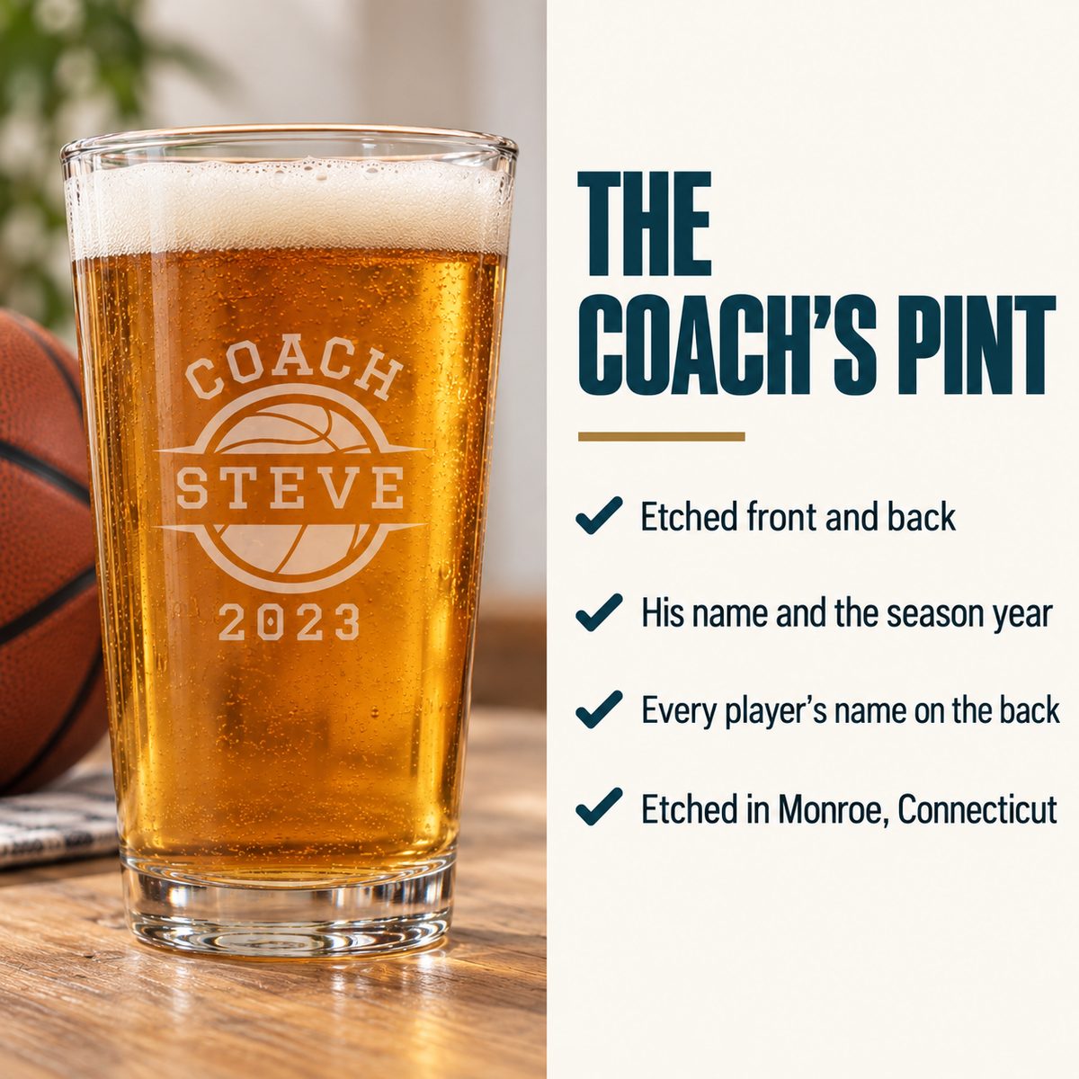 Pint glass filled with amber beer, engraved with basketball and sample personalization reading "COACH STEVE" with date "2023", sitting on wood surface with basketball nearby