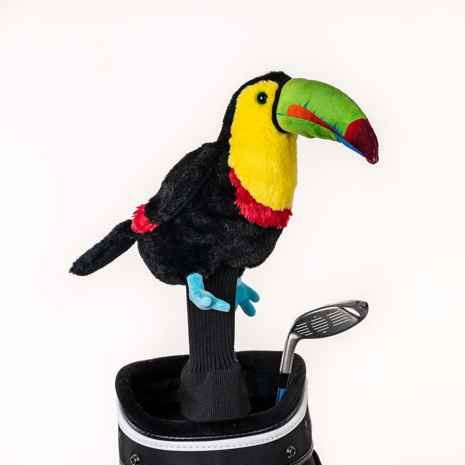 Plush toucan golf headcover covering a club in a golf bag, a standout golf gift for men from Groovy Guy Gifts