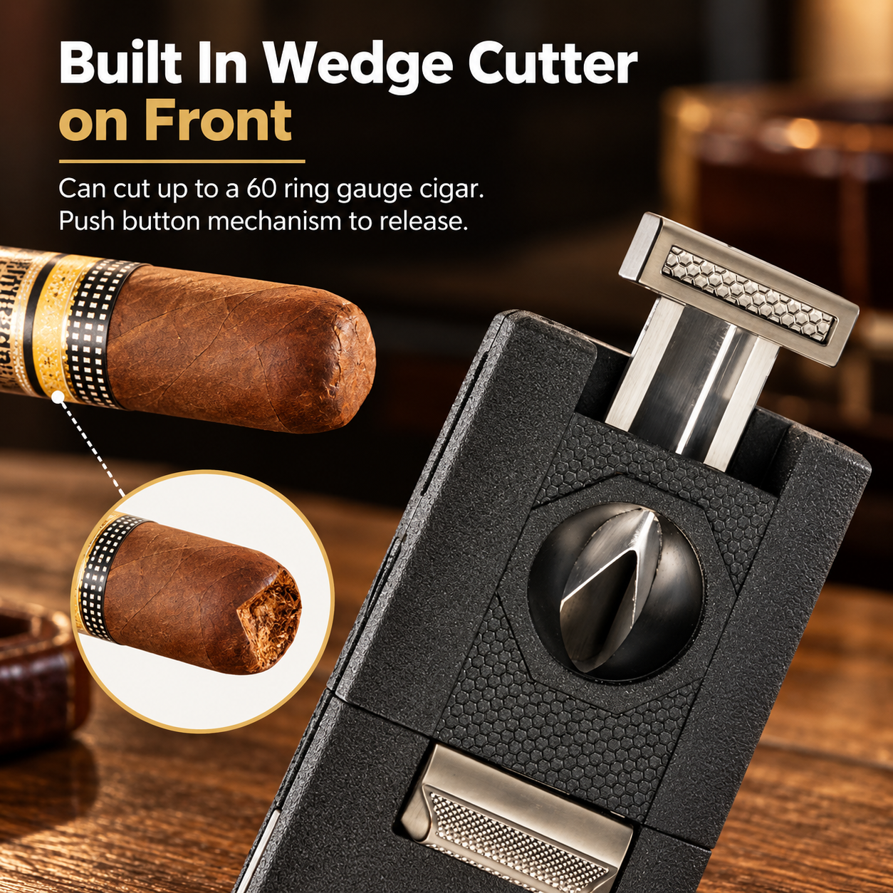 Black and silver cigar cutter with textured case, stainless-steel wedge blade, and push-button release, shown cutting a 60-ring gauge cigar